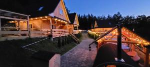 a house with lights on the side of it at night at Cicha Polana in Szczyrk