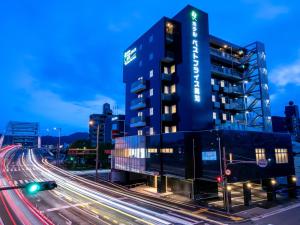 a large blue building on a city street at night at Hotel Best Price Kochi  in Kochi