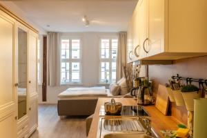 a kitchen with a sink and a living room at Ferienwohnung zum Marktplatz in Wernigerode