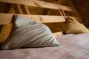 a pair of pillows sitting on a bed at Auru Cīruļi in Auri