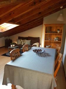 a table with chairs and a couch in a living room at La Buhardilla in Valladolid