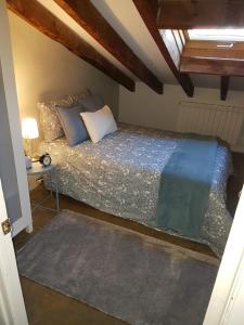 a bedroom with a bed and a table in it at La Buhardilla in Valladolid +31 photos