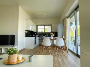 a kitchen with a table and three chairs in a room at WSD Luxury Bright 2BD Apt with Sea view Balcony in Athens