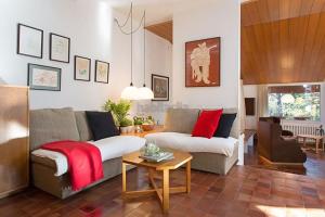 a living room with a couch and a table at El Chalet del Montseny in Seva