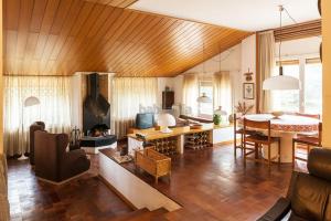 a living room with a table and a dining room at El Chalet del Montseny in Seva