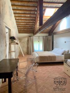 a bedroom with a bed and a table and chairs at Agriturismo Borgo Buzzaccarini Rocca di Castello in Monselice