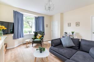 a living room with a black couch and a table at Cosy Home with York Minster Views - Pass the Keys in York