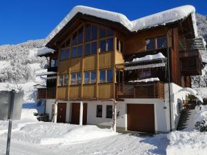 um grande edifício com neve no chão em Appartements Duengler em Schruns