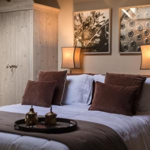 a bedroom with a bed with two pillows and two lamps at La Collina dei Ciliegi in Grezzana
