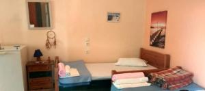 a small bedroom with two beds and a table at Velika seaside Apartment in Velika