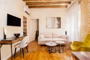 a living room with a couch and a table at Curcumelli Luxury Suites - Κorkira in Corfu