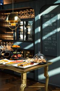 
a table topped with plates of food and drinks at Altstadthotel Weißes Kreuz - In der Fußgängerzone in Innsbruck
