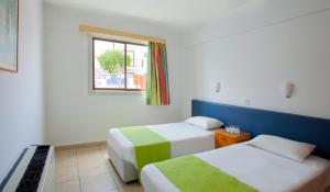 Ένα ή περισσότερα κρεβάτια σε δωμάτιο στο Paloma Hotel Apartments