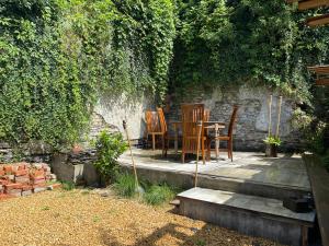 a table and chairs sitting on a patio at Berthe Artist House in La-Roche-en-Ardenne