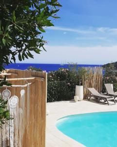 a swimming pool with a view of the ocean at La Côte Bleue in Sainte-Lucie de Porto-Vecchio