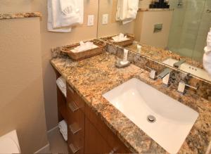 a bathroom with a white sink and a mirror at Lionshead Arcade #303 Condo in Vail +14 photos