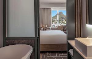 a hotel room with a large bed and a large window at Hyatt Regency Cape Town in Cape Town