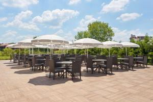 a row of tables and chairs under umbrellas at Ramada by Wyndham Istanbul Sile in Sile