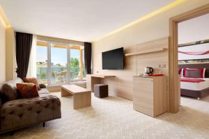 a hotel room with a couch and a bed at Ramada by Wyndham Istanbul Sile in Şile