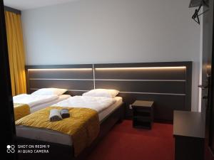 a bedroom with two beds with a headboard at HAVANA in Lublin