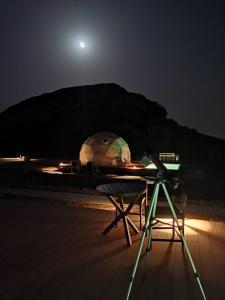 a camera and a tent on the beach at night at Mysk Moon Retreat in Sharjah