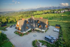 an aerial view of a large house with a parking lot at Hotel REDYK Ski&Relax in Ząb