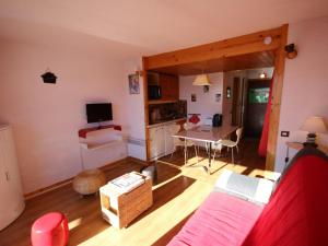 a living room with a couch and a table at Studio Les Saisies, 1 pièce, 4 personnes - FR-1-293-157 in Les Saisies