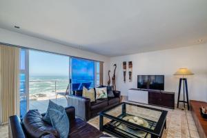 a living room with a view of the ocean at Camps Bay Terrace Penthouse in Cape Town