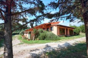 a house in the middle of a yard with a tree at La dimora degli Etruschi in Civitella Cesi
