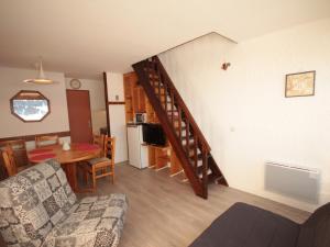 a living room with a staircase and a dining room at Appartement Les Saisies, 2 pièces, 7 personnes - FR-1-293-221 in Les Saisies