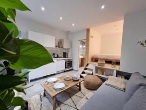 a living room with a couch and a table at CABANA & Bois Dormant - Proche du Lac in Sévrier