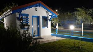 a small house with a blue door at night at Complex Turistic Essenza in Murighiol