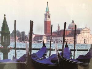 two gondolas in the water in front of a building at Hotel Venice Tour in Mestre