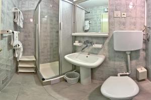 a bathroom with a sink and a toilet and a shower at Villa Šoulavy in Kaštela +15 photos