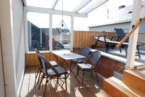 a patio with chairs and a table on a deck at Ferienunterkunft Vulkaneifel - Baltes-Haus in Brockscheid