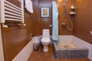 a bathroom with a toilet and a shower at Kindli Boutique Hotel in Tbilisi City