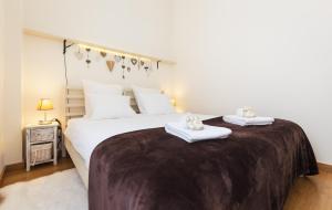 a bedroom with a large bed with towels on it at The Sunset Hideout in Lisbon