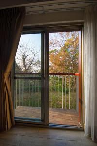 a sliding glass door with a view of a porch at 南窩綠丘-綠丘行旅-2萬坪庭園 in Tongxiao