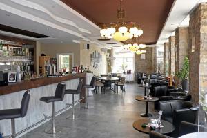 a bar with black chairs and tables in a restaurant at Hotel Danner in Rheinfelden