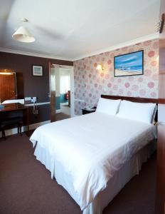 a hotel room with a large bed and a large window at Pontac House Hotel in St Clements