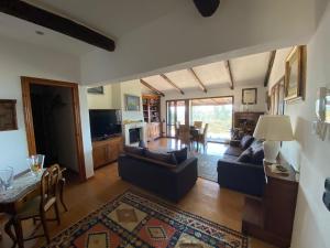 a living room with two couches and a dining room at Casa ai Poggi dell'Argentario in Orbetello