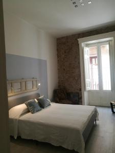 1 dormitorio con 1 cama grande en una habitación en Al Campanile, en Piazza Armerina