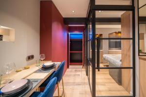 a dining room with a long table and blue chairs at Le Luxury Design de la Vieille Ville in Annecy