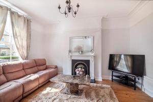 a living room with a couch and a fireplace at 17 Penleys Grove Street in York