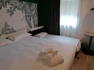 The Originals City Hôtel Bordeaux Porte du Bassin客房内的一张或多张床位