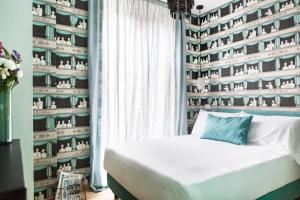 a bedroom with a bed and a wall of shelves at Salotto Monti in Rome