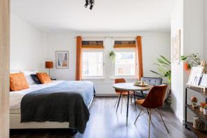 a bedroom with a bed and a table with chairs at Citystays Deventer in Deventer