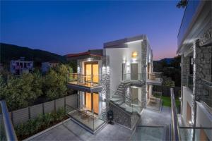 a view of a house from a balcony at ALPE LUXURY ACCOMMODATION Penelope Collection in Olympiada