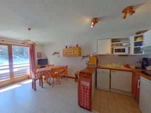 a kitchen with a table and a dining room at Appartement La Tania, 3 pièces, 7 personnes - FR-1-513-38 in La Tania
