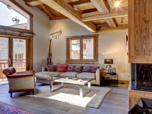 a living room with a couch and a table at Chalet Courchevel, 5 pièces, 9 personnes - FR-1-514-20 in le Praz